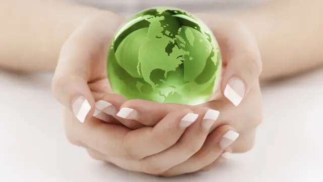 Hands holding a green globe